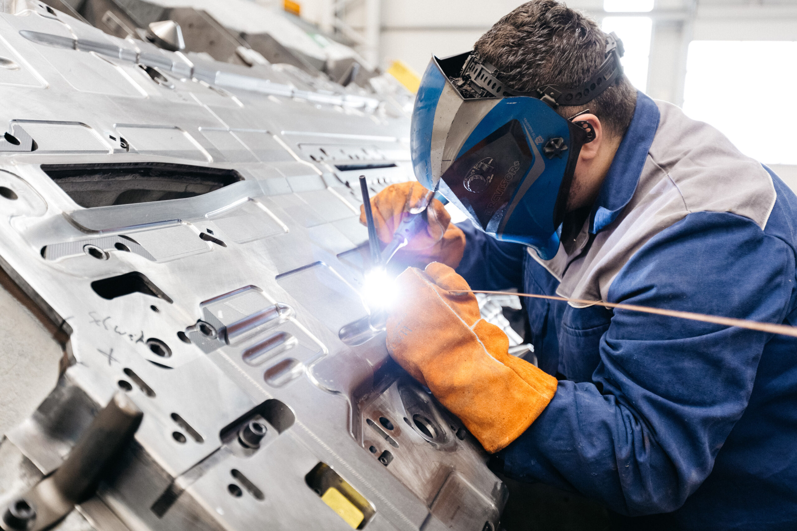 a man with a welding mask is welding something